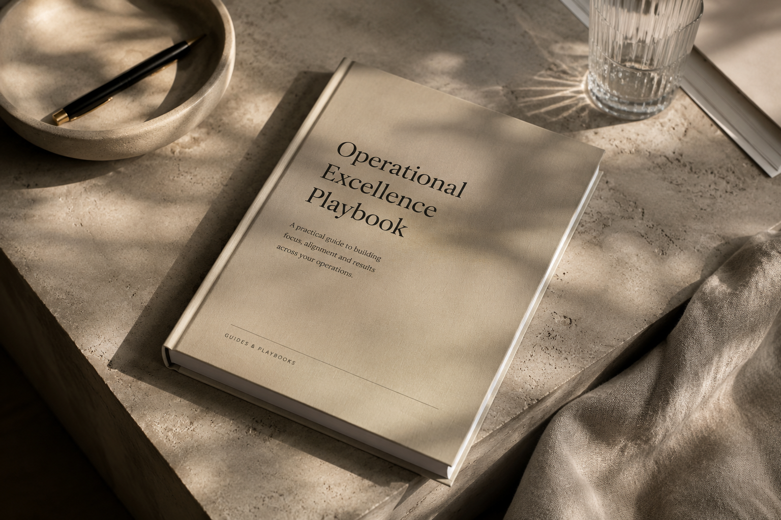 A cloth-bound playbook resting on a stone surface in soft daylight