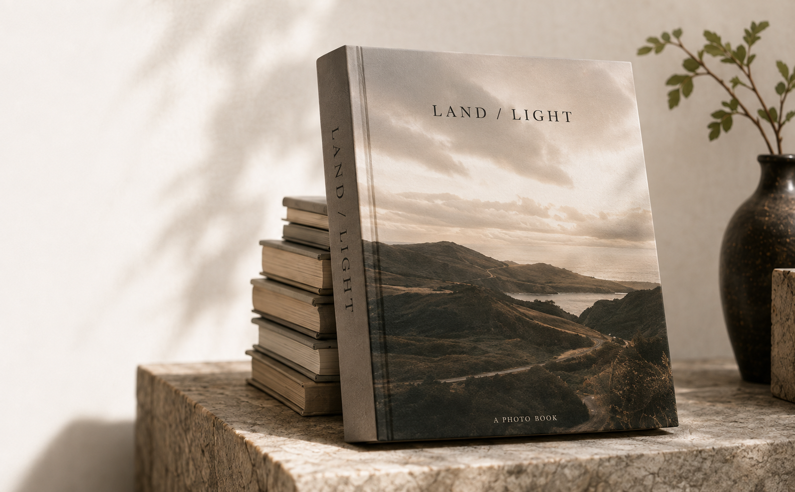 A large photo book standing on a stone ledge in warm natural light