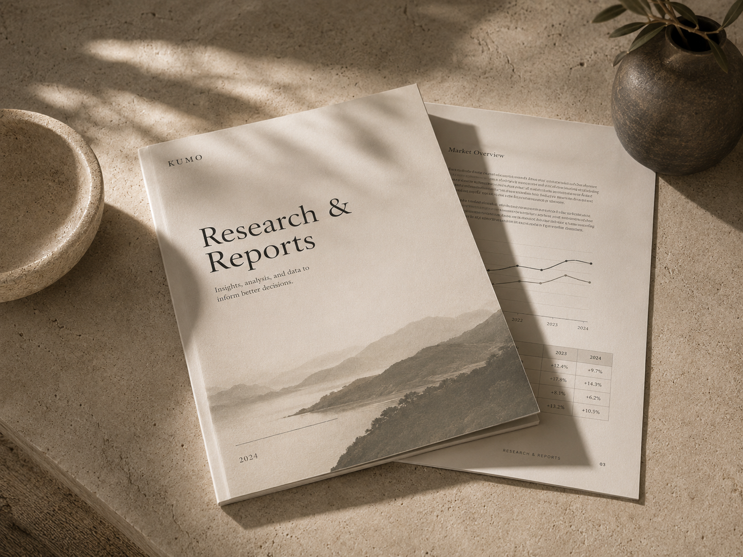 A printed research report laid on a stone surface with quiet shadows